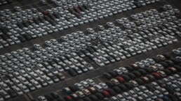 overhead shot of parked cars in a large lot.